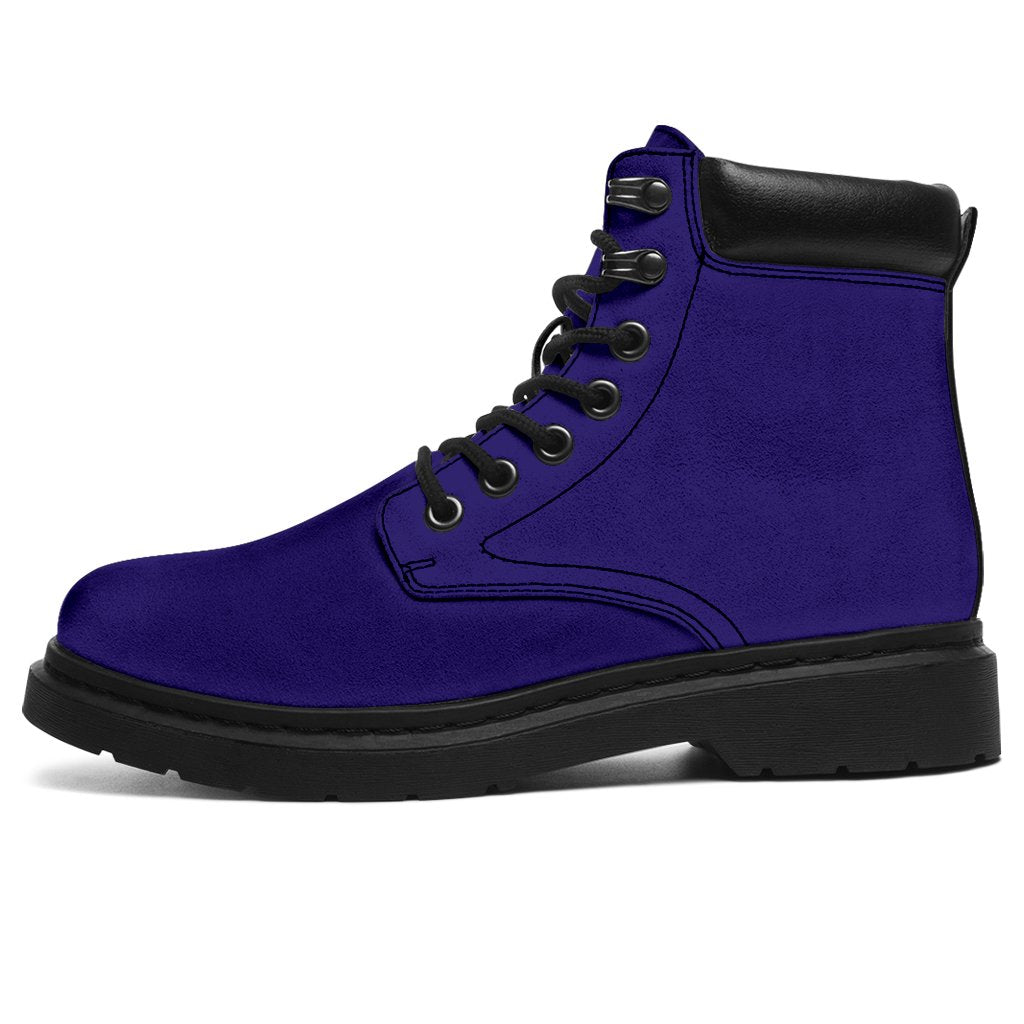 This is a microsuede pair of boots for men and women. It is a purple colour all over. The boot has a black sole black trim, black laces, and sits above the ankle. It is set on a white background.