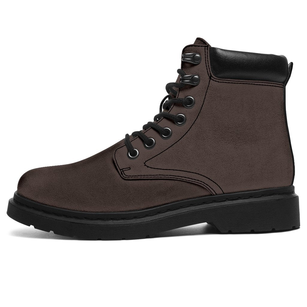 This is a microsuede pair of boots for men and women. It is a dark chocolate colour all over. The boot has a black sole black trim, black laces, and sits above the ankle. It is set on a white background.