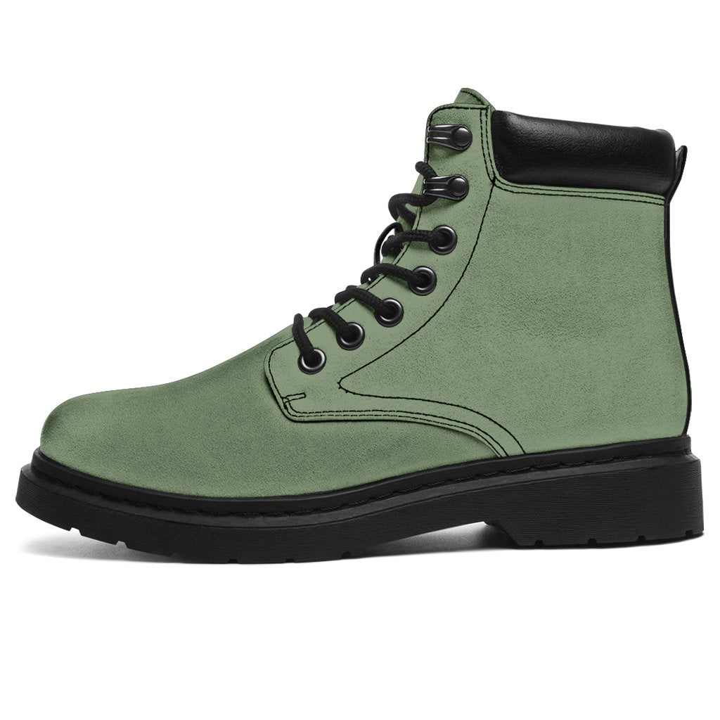 This is a microsuede pair of boots for men and women. It is a deep mint green colour all over. The boot has a black sole black trim, black laces, and sits above the ankle. It is set on a white background.