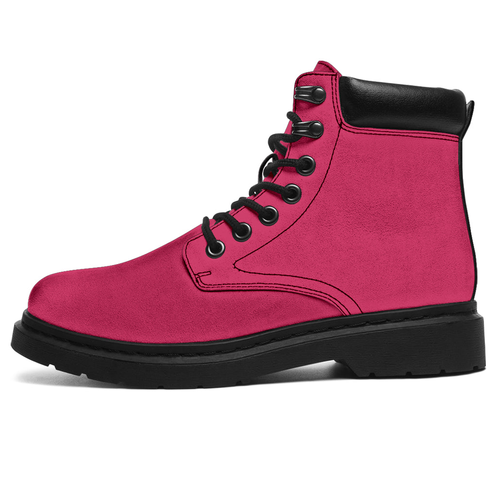 This is a microsuede pair of boots for men and women. It is a hot pink colour all over. The boot has a black sole black trim, black laces, and sits above the ankle. It is set on a white background.