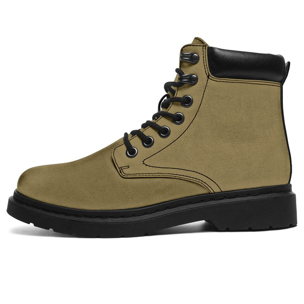 This is a microsuede pair of boots for men and women. It is a light khaki colour all over. The boot has a black sole black trim, black laces, and sits above the ankle. It is set on a white background.