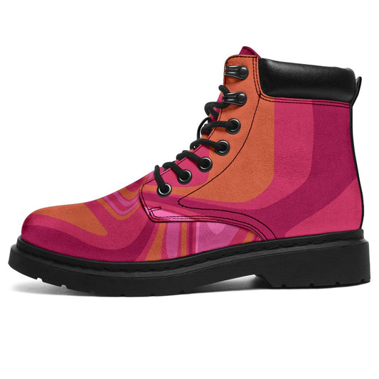 This is a microsuede pair of boots for men and women. It has pink and orange swirls all over the boots. The boot has a black sole black trim , black laces, and sits above the ankle. It is set on a white background.