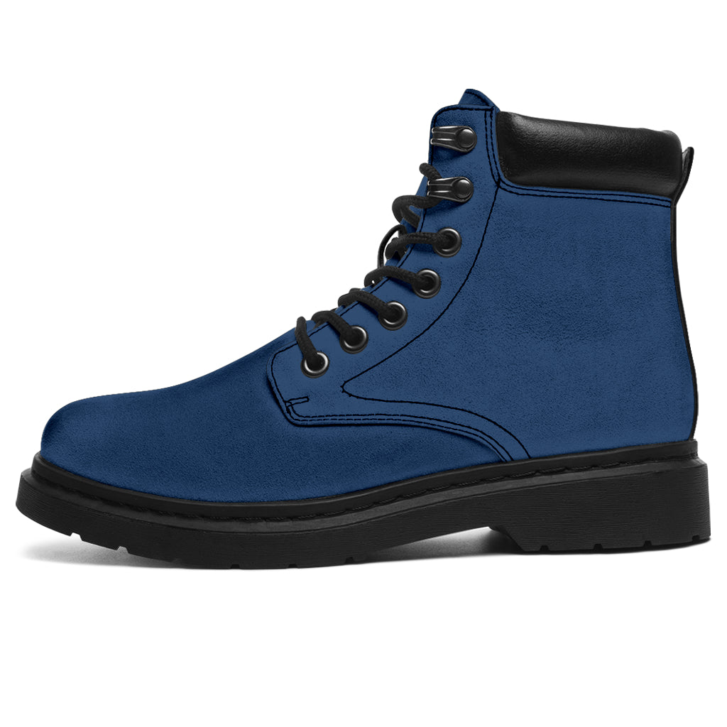 This is a microsuede pair of boots for men and women. It is a ink blue colour all over. The boot has a black sole black trim, black laces, and sits above the ankle. It is set on a white background.