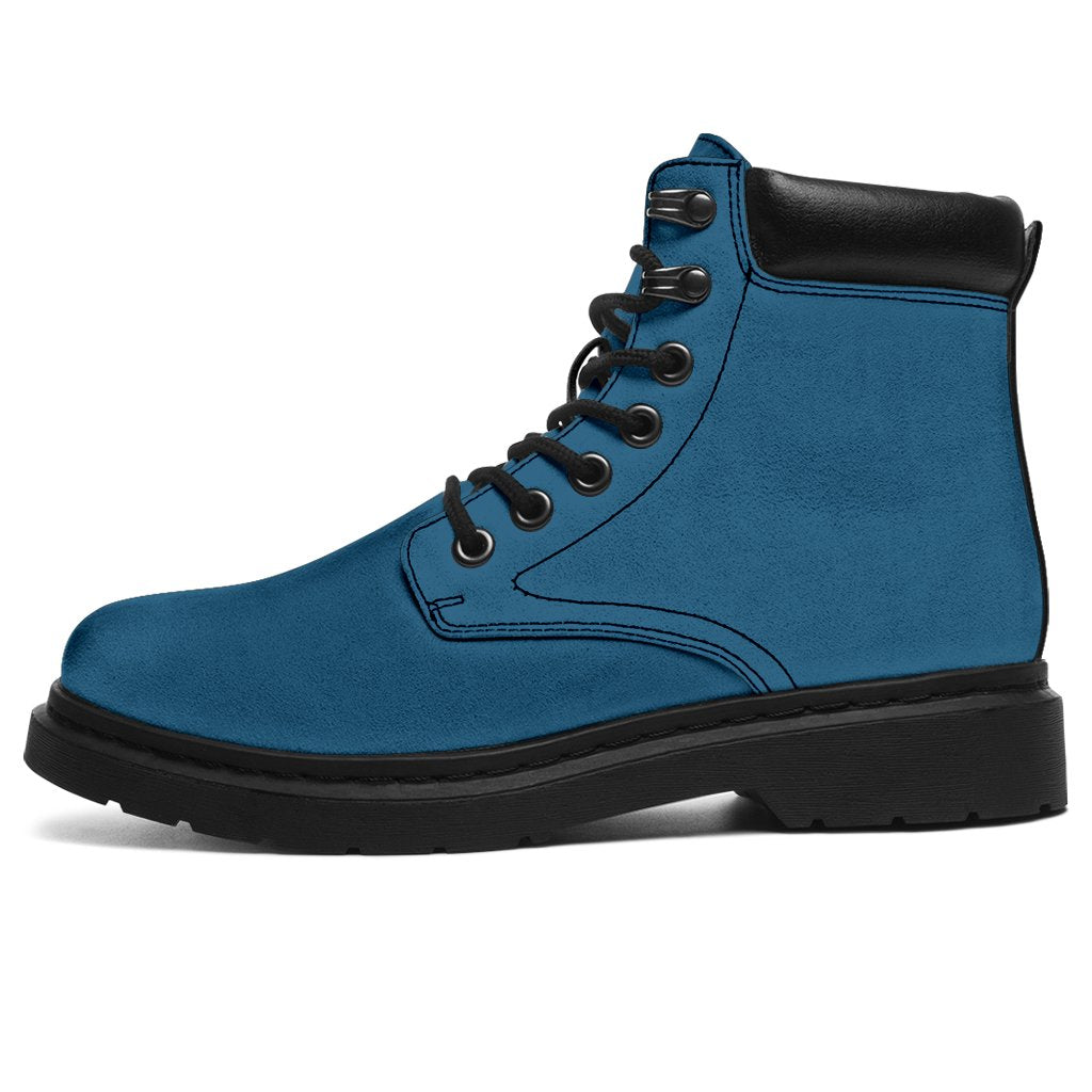 This is a microsuede pair of boots for men and women. It is a vintage sky colour all over. The boot has a black sole black trim, black laces, and sits above the ankle. It is set on a white background.