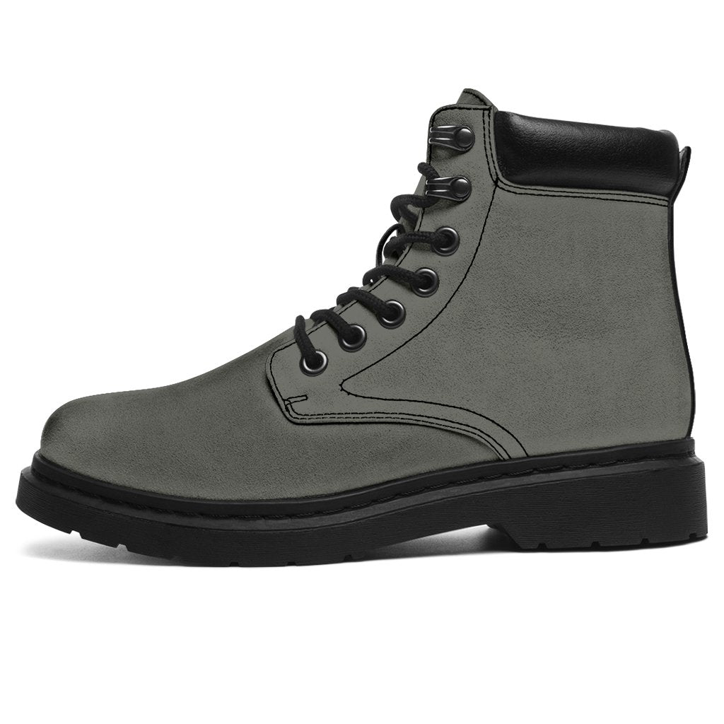 This is a microsuede pair of boots for men and women. It is a grey colour all over. The boot has a black sole black trim, black laces, and sits above the ankle. It is set on a white background.