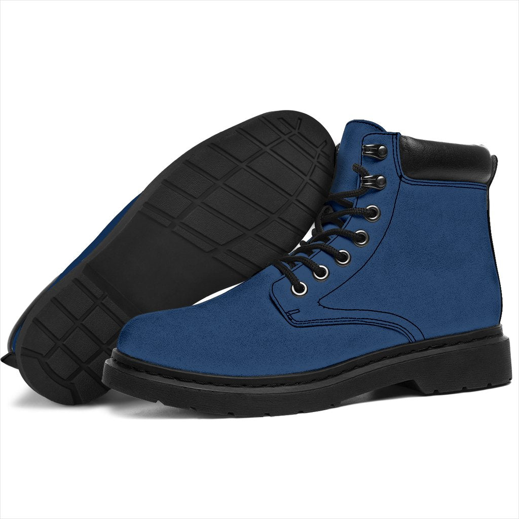 This is a microsuede pair of boots for men and women. It is a ink blue colour all over. The boot has a black sole black trim, black laces, and sits above the ankle. It is set on a white background.