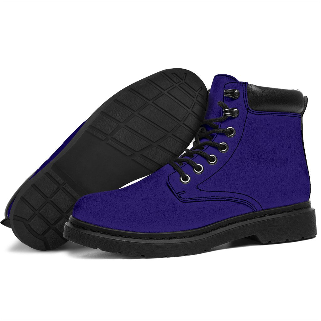 This is a microsuede pair of boots for men and women. It is a dark purple colour all over. The boot has a black sole black trim, black laces, and sits above the ankle. It is set on a white background.