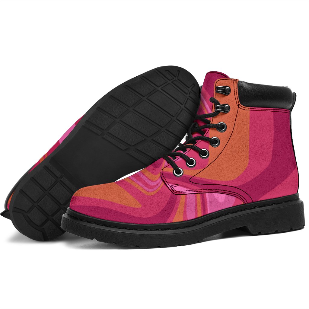 This is a microsuede pair of boots for men and women. It has pink and orange swirls all over the boots. The boot has a black sole black trim , black laces, and sits above the ankle. It is set on a white background.