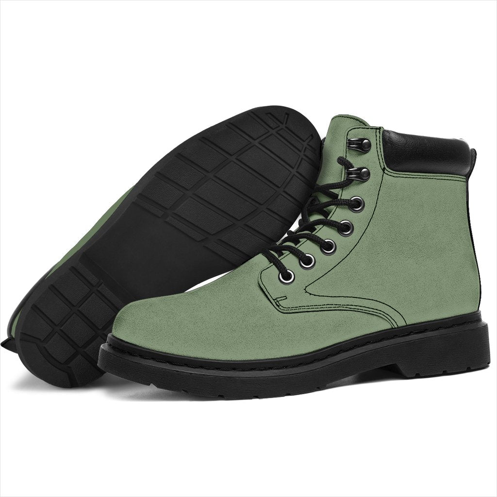 This is a microsuede pair of boots for men and women. It is a deep mint green colour all over. The boot has a black sole black trim, black laces, and sits above the ankle. It is set on a white background.