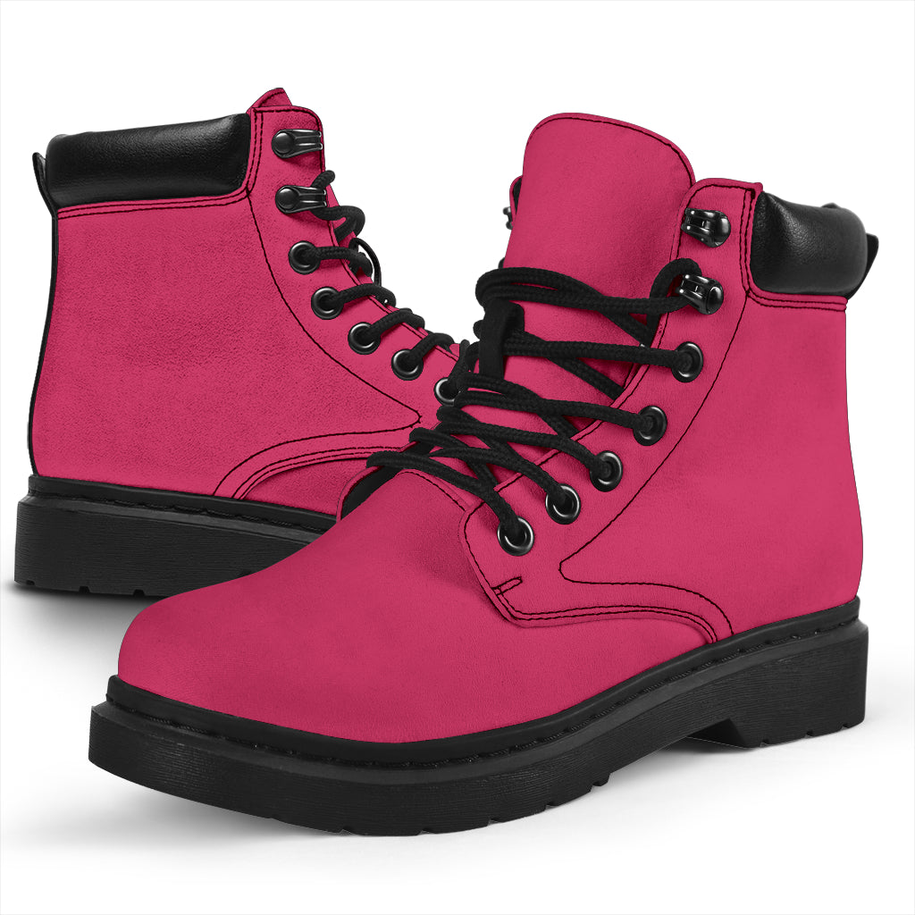 This is a microsuede pair of boots for men and women. It is a hot pink colour all over. The boot has a black sole black trim, black laces, and sits above the ankle. It is set on a white background.