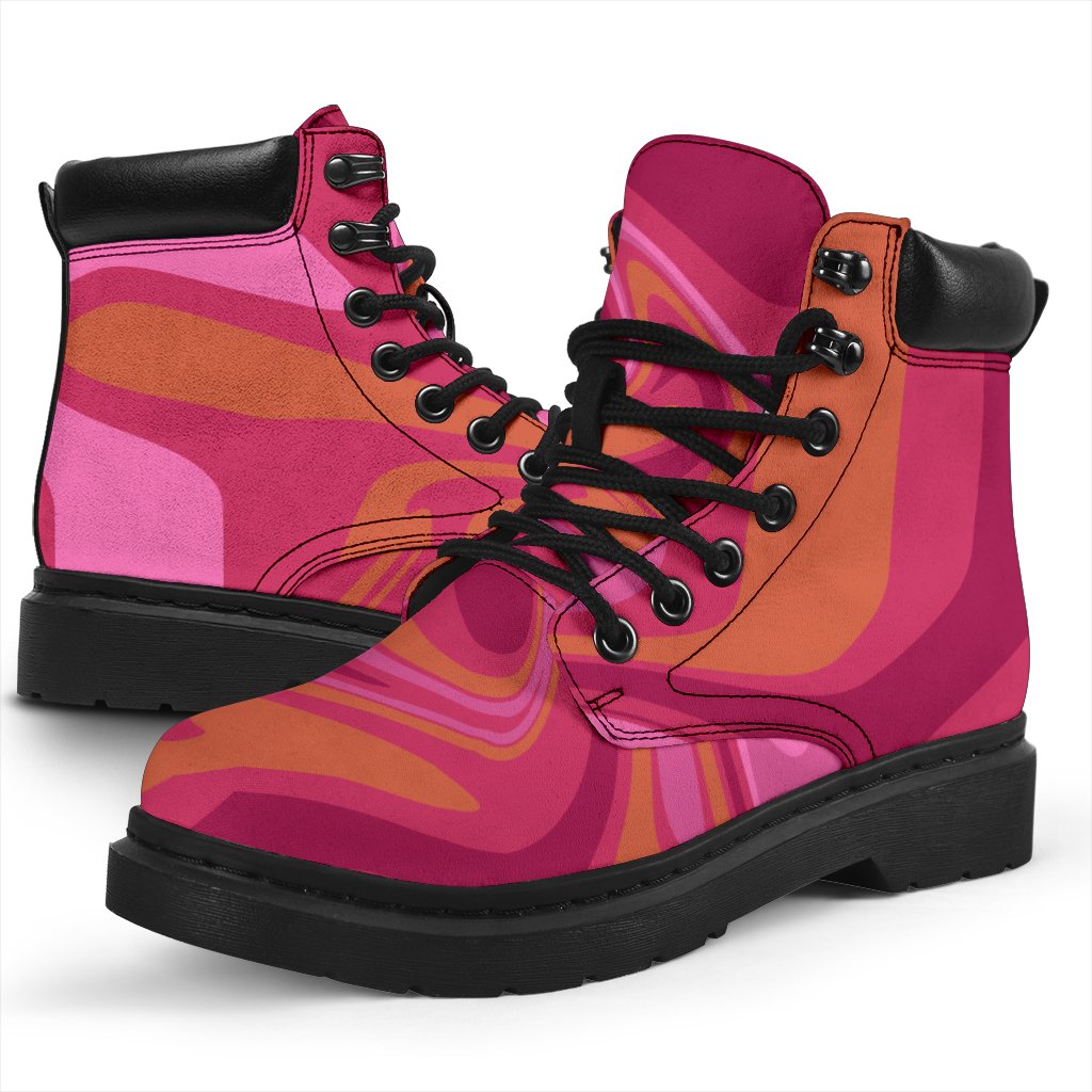 This is a microsuede pair of boots for men and women. It has pink and orange swirls all over the boots. The boot has a black sole black trim , black laces, and sits above the ankle. It is set on a white background.