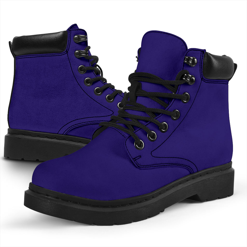 This is a microsuede pair of boots for men and women. It is a dark purple colour all over. The boot has a black sole black trim, black laces, and sits above the ankle. It is set on a white background.