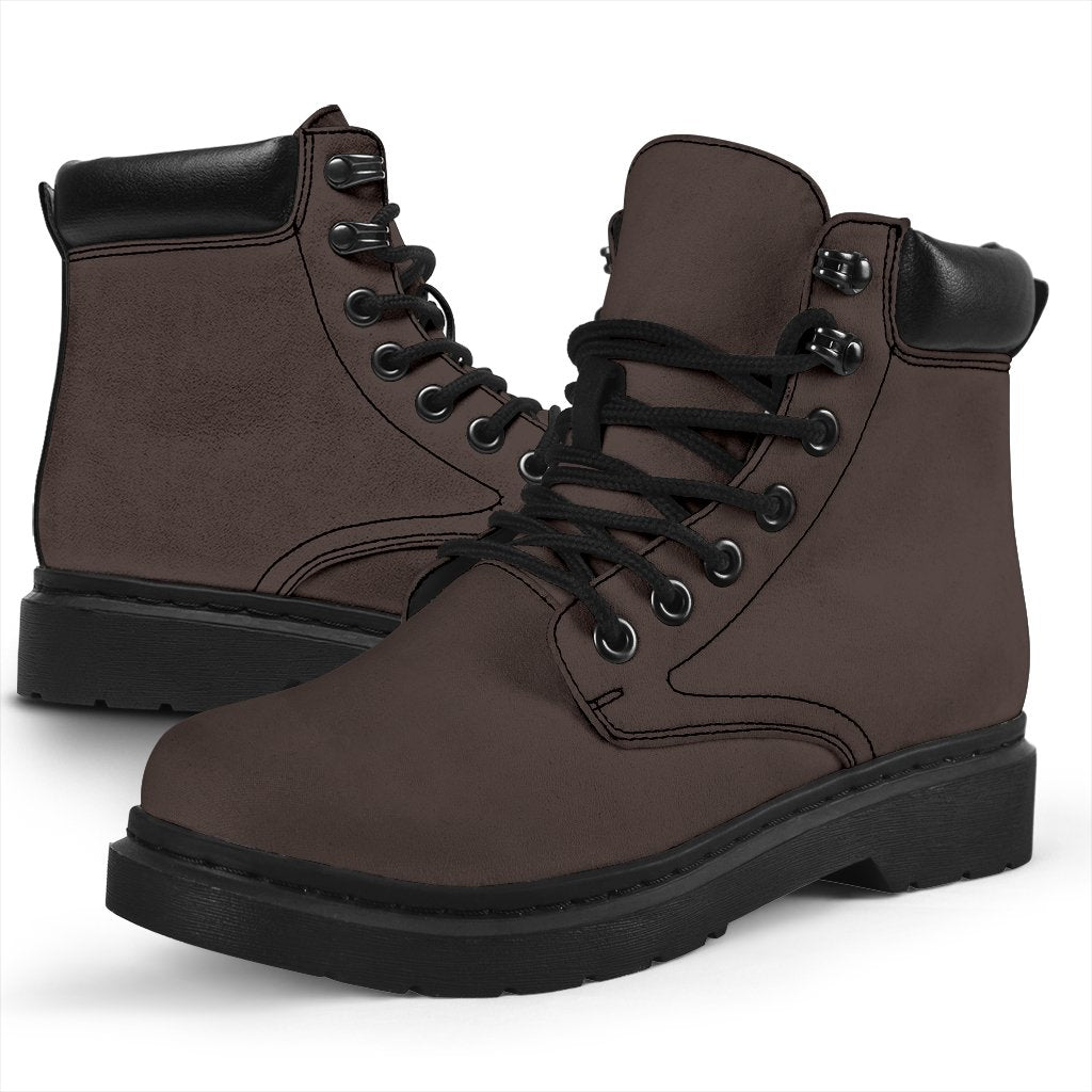 This is a microsuede pair of boots for men and women. It is a dark chocolate colour all over. The boot has a black sole black trim, black laces, and sits above the ankle. It is set on a white background.