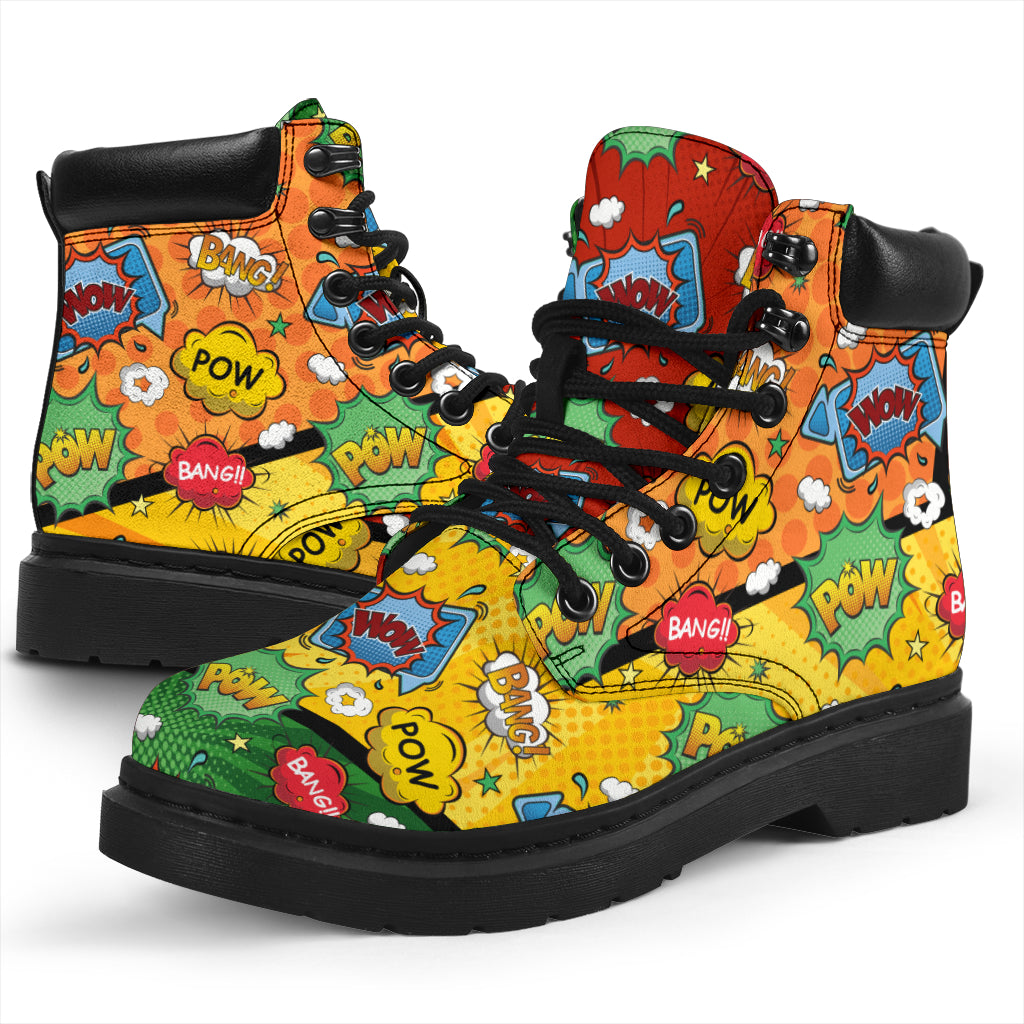 This is a microsuede pair of boots for men and women. It has a comic print, with words saying pow, bang, wow, in stars and clouds. In orange, yellow, green, blue, and red colours all over the boots. The boot has a black sole black trim , black laces, and sits above the ankle. It is set on a white background.