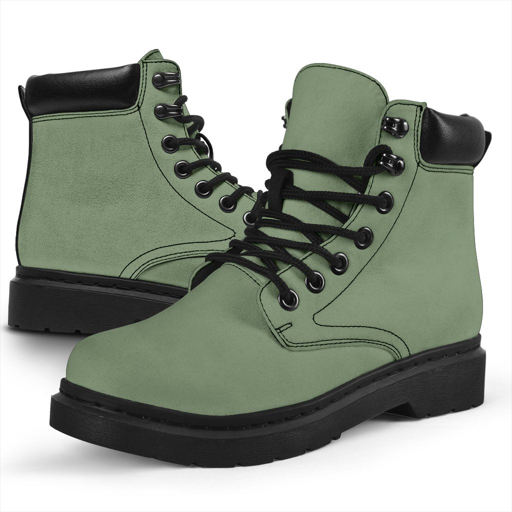 This is a microsuede pair of boots for men and women. It is a deep mint green colour all over. The boot has a black sole black trim, black laces, and sits above the ankle. It is set on a white background.