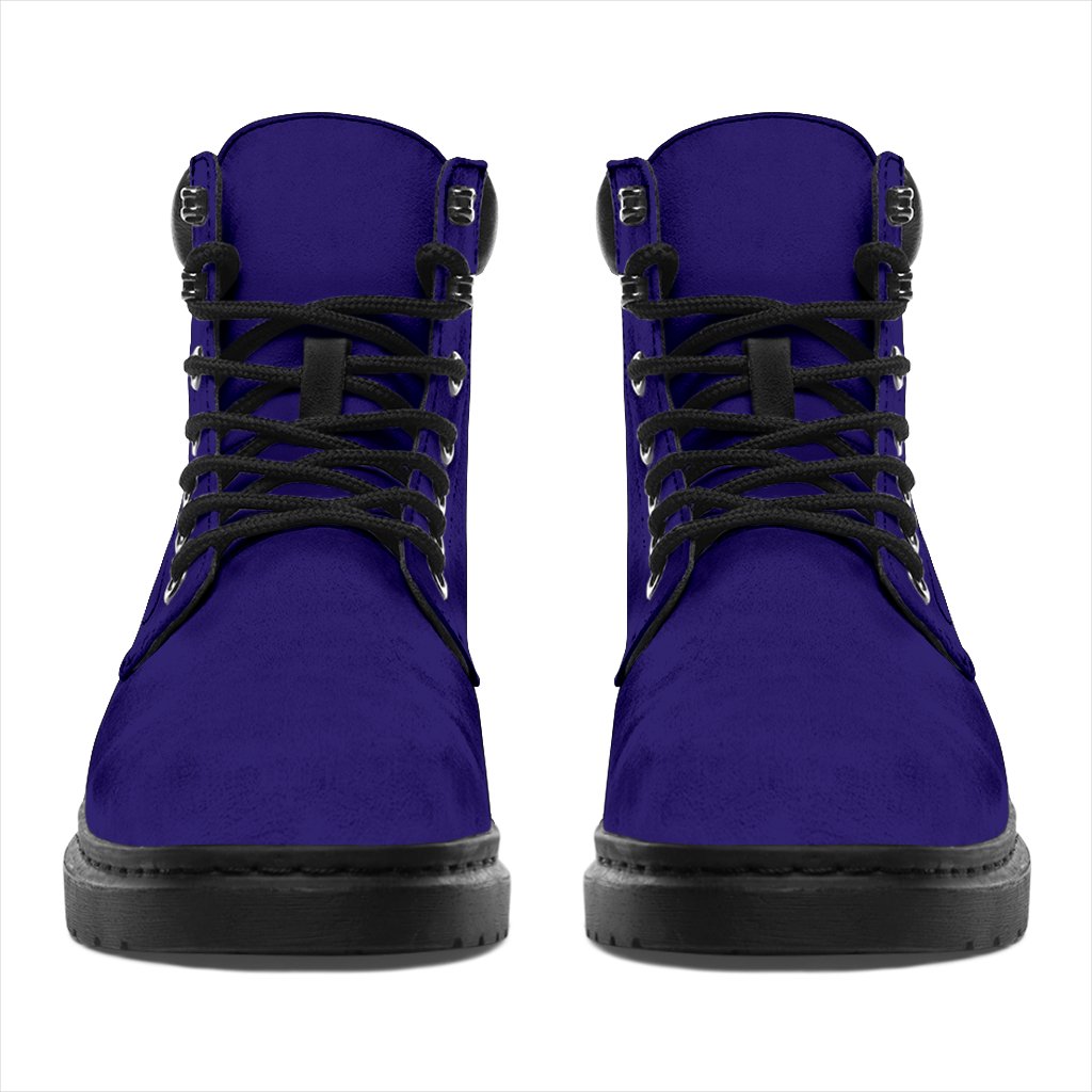 This is a microsuede pair of boots for men and women. It is a dark purple colour all over. The boot has a black sole black trim, black laces, and sits above the ankle. It is set on a white background.