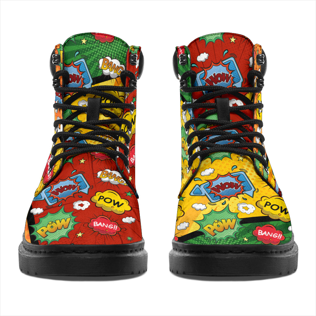 This is a microsuede pair of boots for men and women. It has a comic print, with words saying pow, bang, wow, in stars and clouds. In orange, yellow, green, blue, and red colours all over the boots. The boot has a black sole black trim , black laces, and sits above the ankle. It is set on a white background.