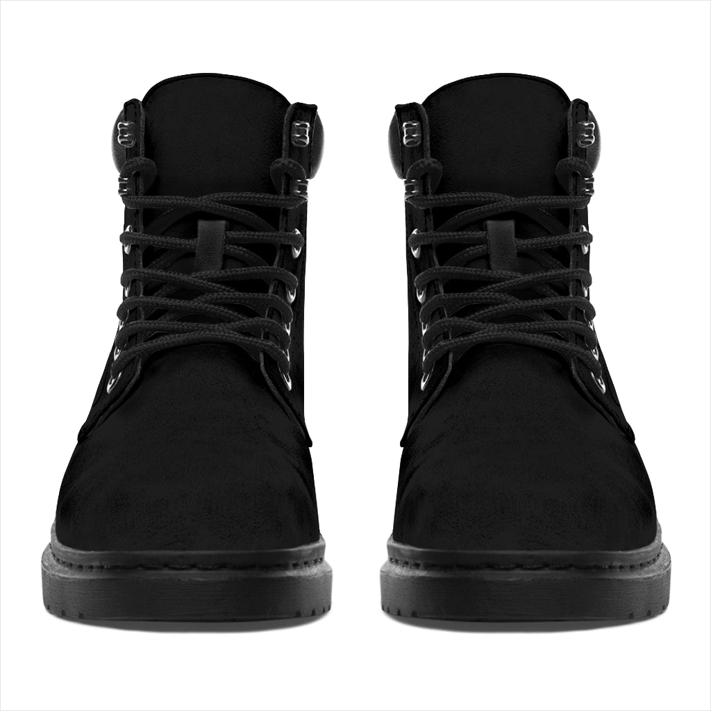 This is a microsuede pair of boots for men and women. It is a black colour all over. The boot has a black sole black trim, black laces, and sits above the ankle. It is set on a white background.