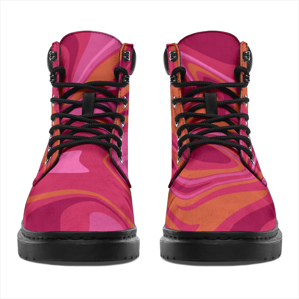 This is a microsuede pair of boots for men and women. It has pink and orange swirls all over the boots. The boot has a black sole black trim , black laces, and sits above the ankle. It is set on a white background.