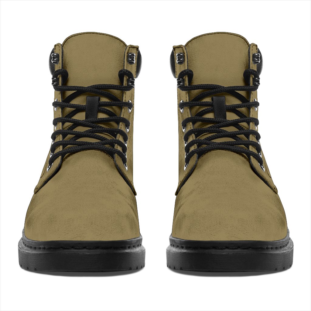 This is a microsuede pair of boots for men and women. It is a light khaki colour all over. The boot has a black sole black trim, black laces, and sits above the ankle. It is set on a white background.