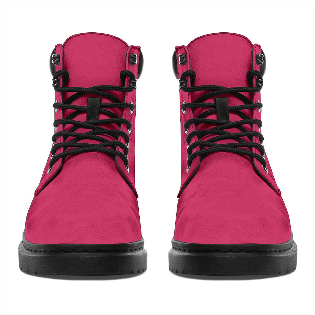 This is a microsuede pair of boots for men and women. It is a hot pink colour all over. The boot has a black sole black trim, black laces, and sits above the ankle. It is set on a white background.